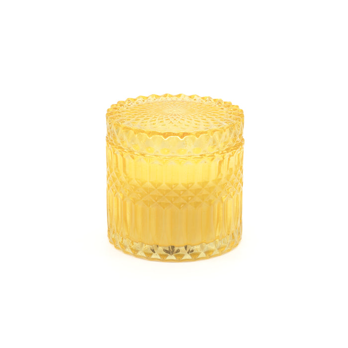 Candela di cera in bicchiere giallo