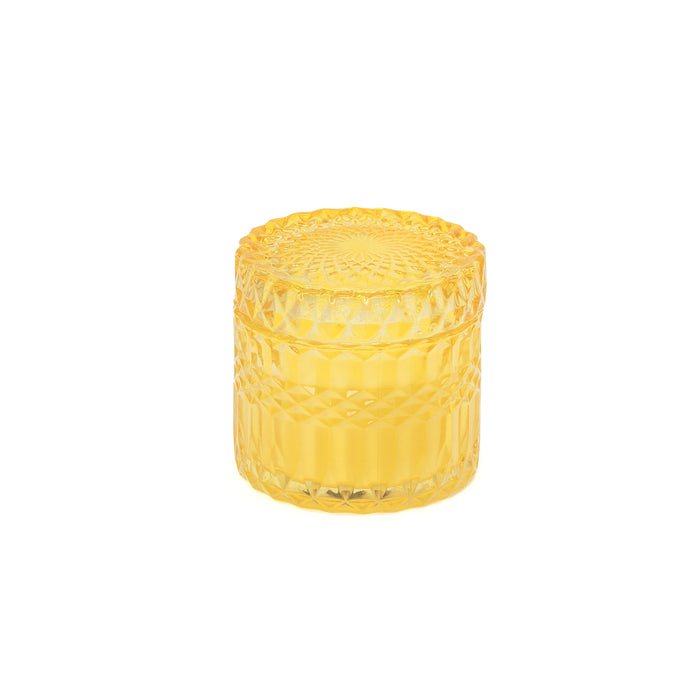 Candela di cera in bicchiere giallo